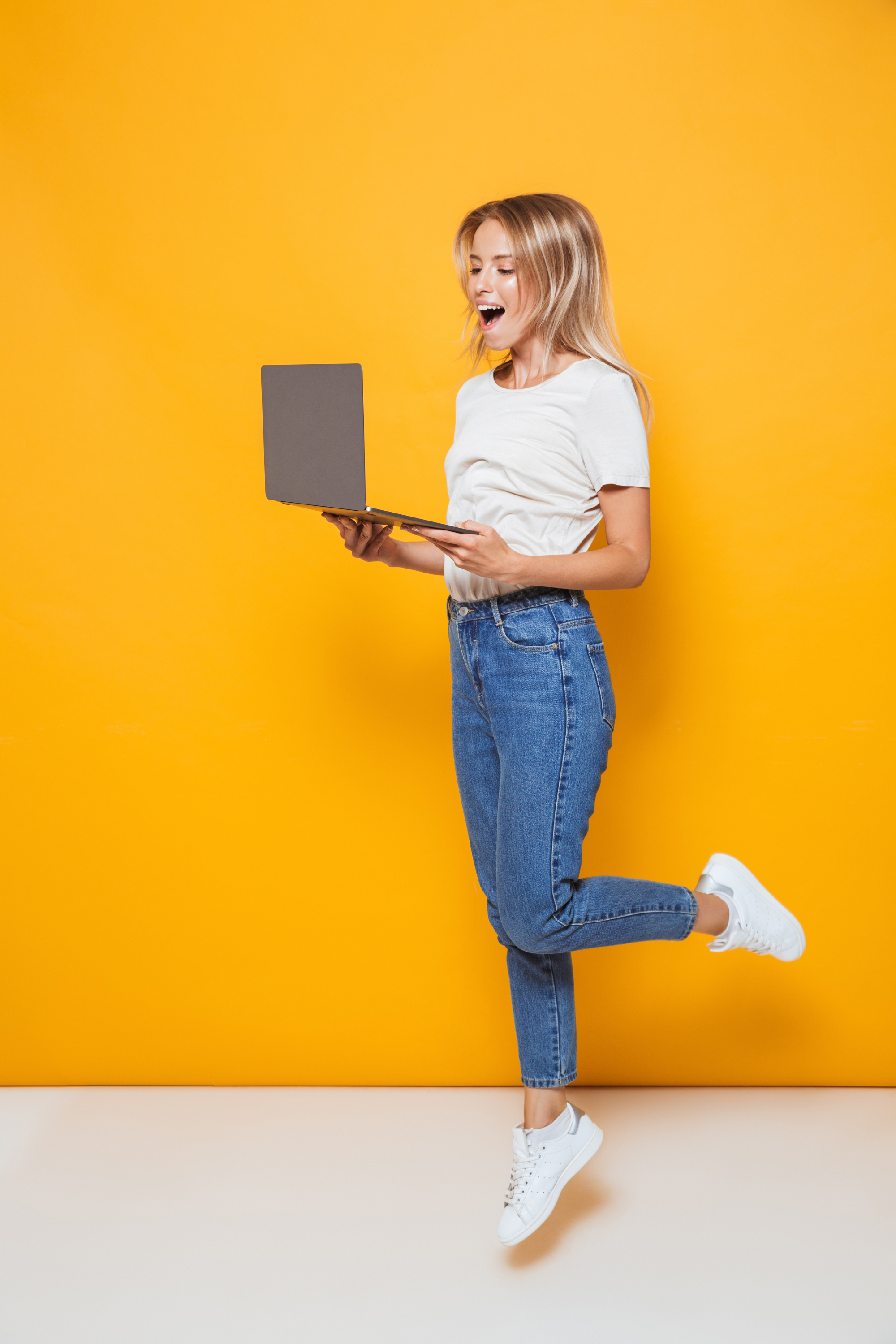 Nonprofit professional training online with laptop against yellow background